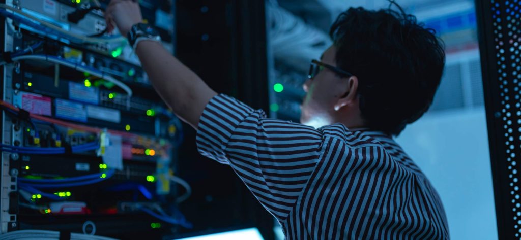 man reaching to server