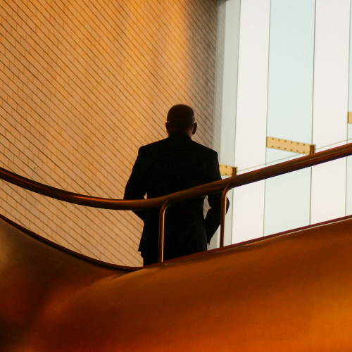 image of back of man in corporate setting