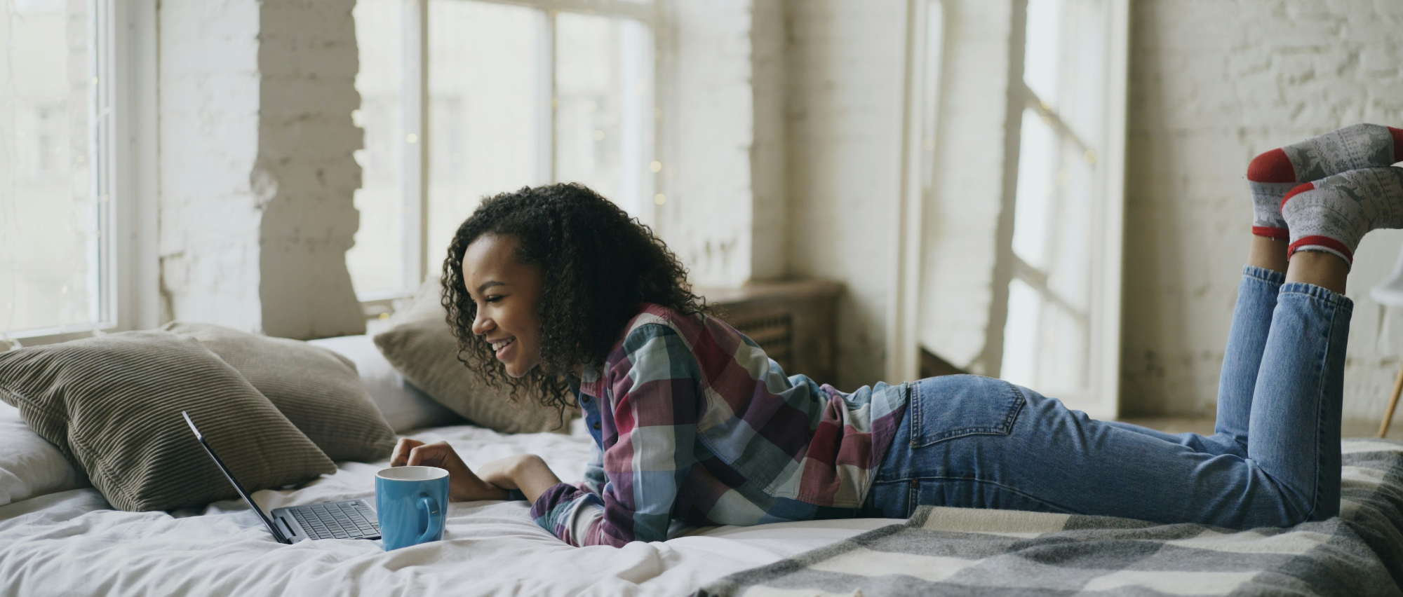 woman on computer drinking coffee